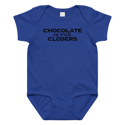 "Chocolate Is For Closers" printed on a royal baby jersey bodysuit laying on a flat surface amongst other clothes