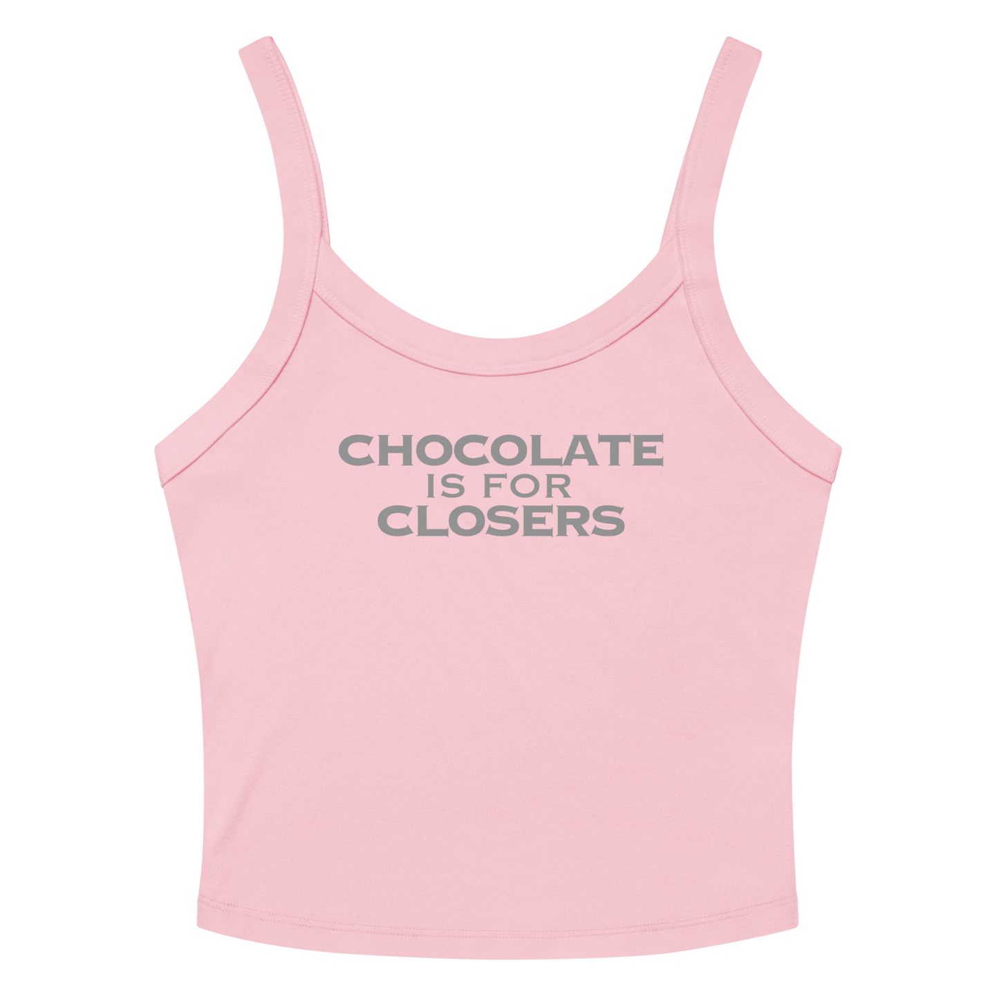 "Chocolate Is For Closers" printed on a solid pink blend women's micro-rib tanktop laying on a flat surface amongst sunglasses and shorts