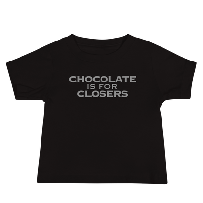 "Chocolate Is For Closers" printed on a black baby jersey short sleeve tee laying on a flat surface