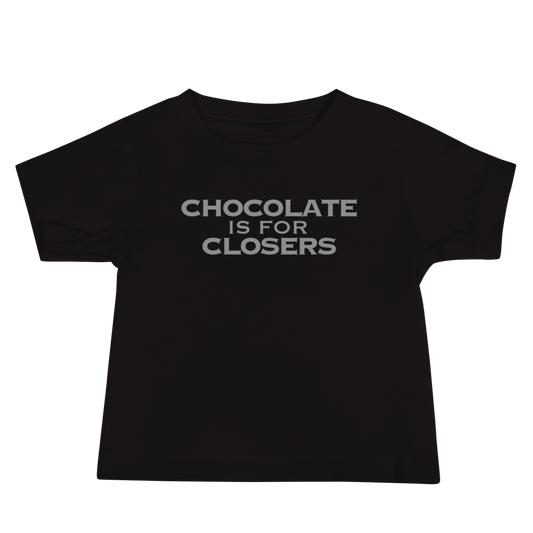 "Chocolate Is For Closers" printed on a black baby jersey short sleeve tee laying on a flat surface
