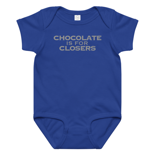 "Chocolate Is For Closers" printed on a royal baby jersey bodysuit laying on a flat surface amongst other clothes