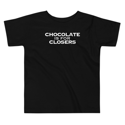 "Chocolate Is For Closers" printed on a black toddler short sleeve tee laying on a flat surface