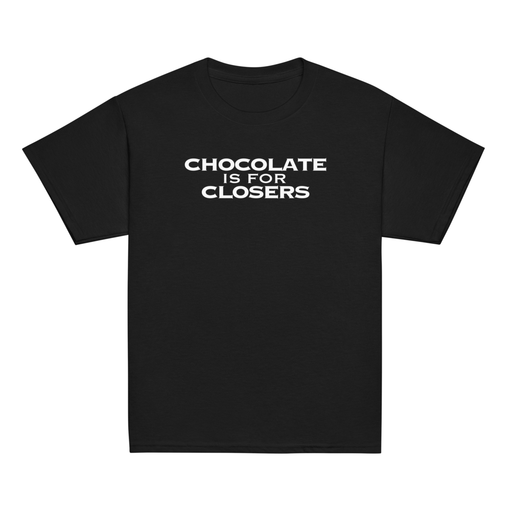 "Chocolate Is For Closers" printed on a black youth classic tee laying on a flat surface