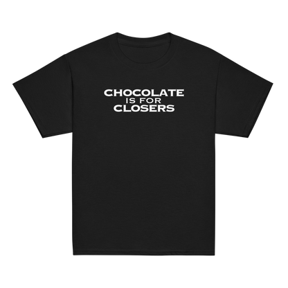 "Chocolate Is For Closers" printed on a black youth classic tee laying on a flat surface
