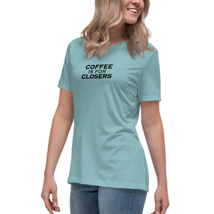 "Coffee Is For Closers" printed on a heather blue lagoon women's relaxed t-shirt worn by a female