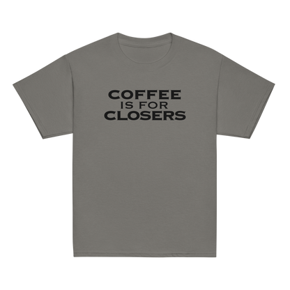 "Coffee Is For Closers" printed on a charcoal youth classic tee laying on a flat surface