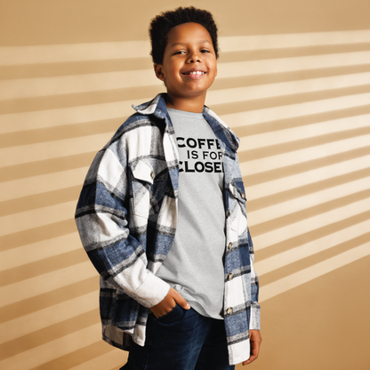 "Coffee Is For Closers" printed on a sport grey youth classic tee worn by a male also wearing a jacket