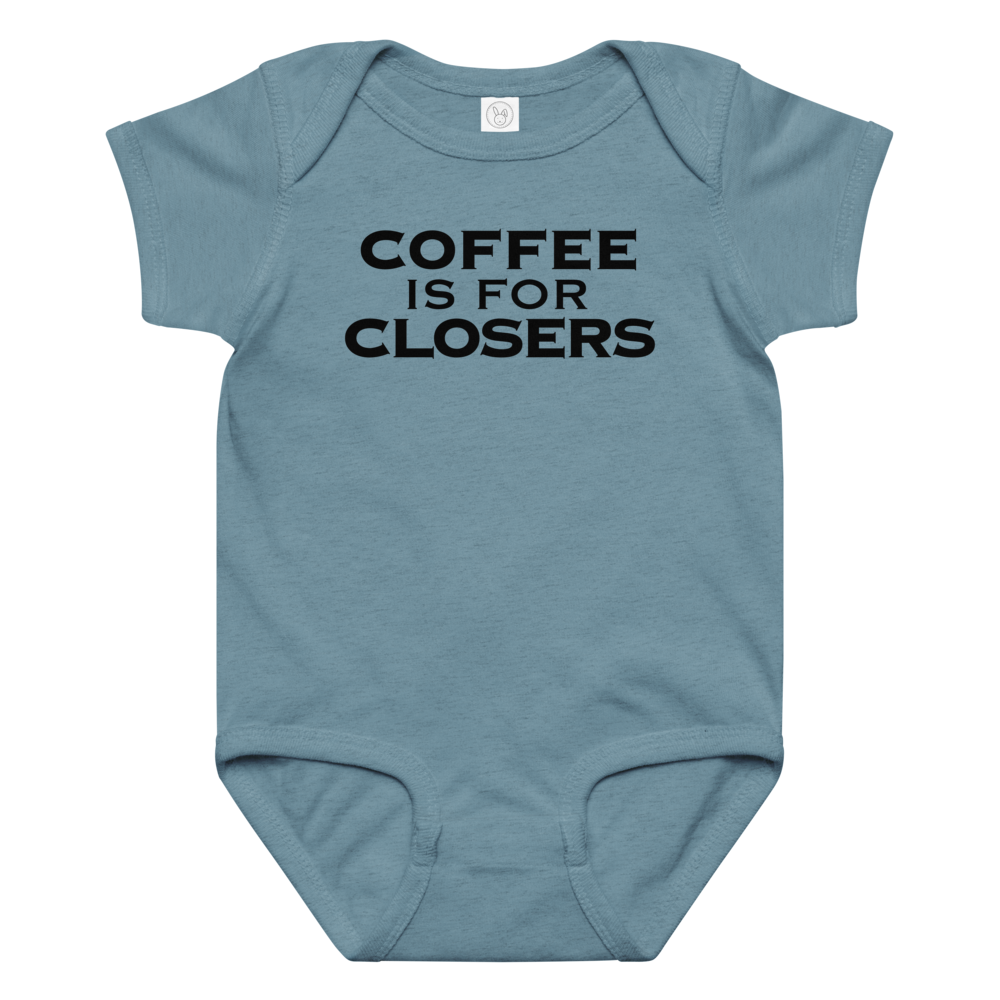 "Coffee Is For Closers" printed on a vintage indigo baby jersey bodysuit laying on a flat surface amongst other clothes