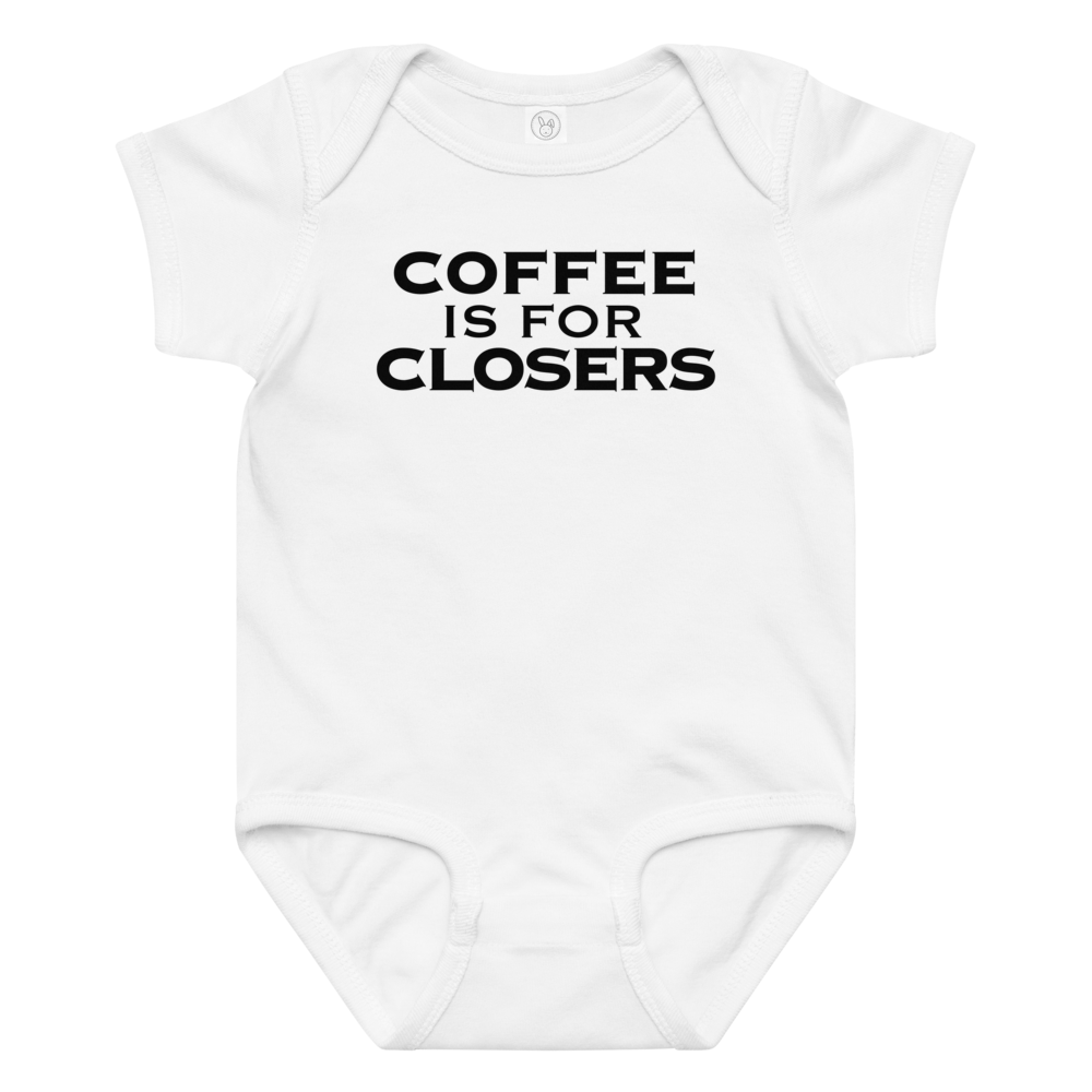 "Coffee Is For Closers" printed on a white baby jersey bodysuit laying on a flat surface amongst other clothes