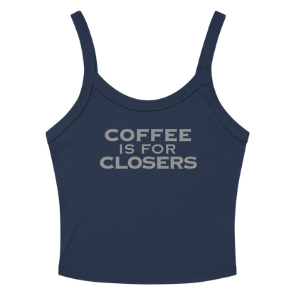 "Coffee Is For Closers" printed on a solid navy blend women's micro-rib tanktop laying on a flat surface amongst sunglasses and shorts