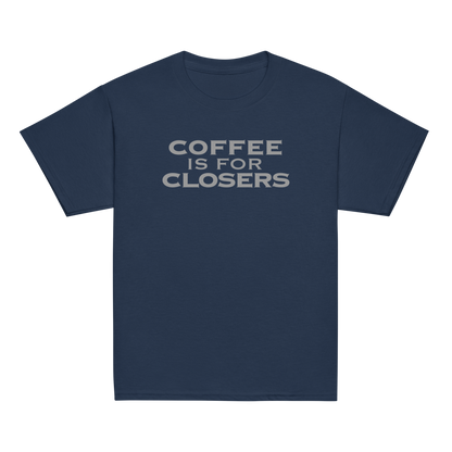 "Coffee Is For Closers" printed on a navy youth classic tee laying on a flat surface