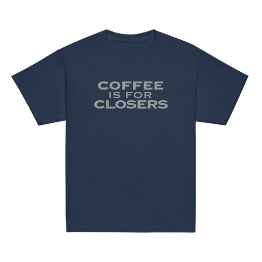 "Coffee Is For Closers" printed on a navy youth classic tee laying on a flat surface
