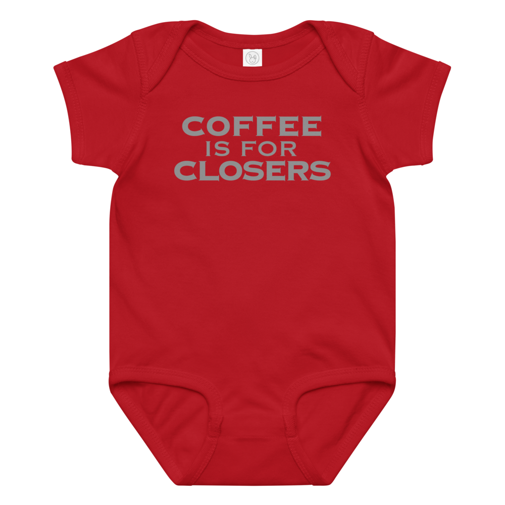 "Coffee Is For Closers" printed on a red baby jersey bodysuit laying on a flat surface amongst other clothes