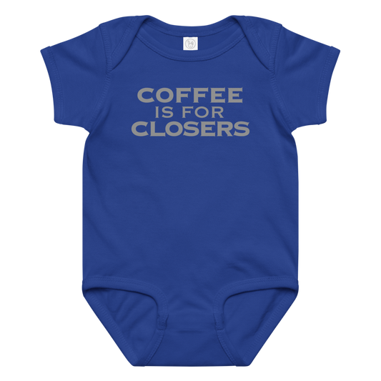 "Coffee Is For Closers" printed on a royal baby jersey bodysuit laying on a flat surface amongst other clothes
