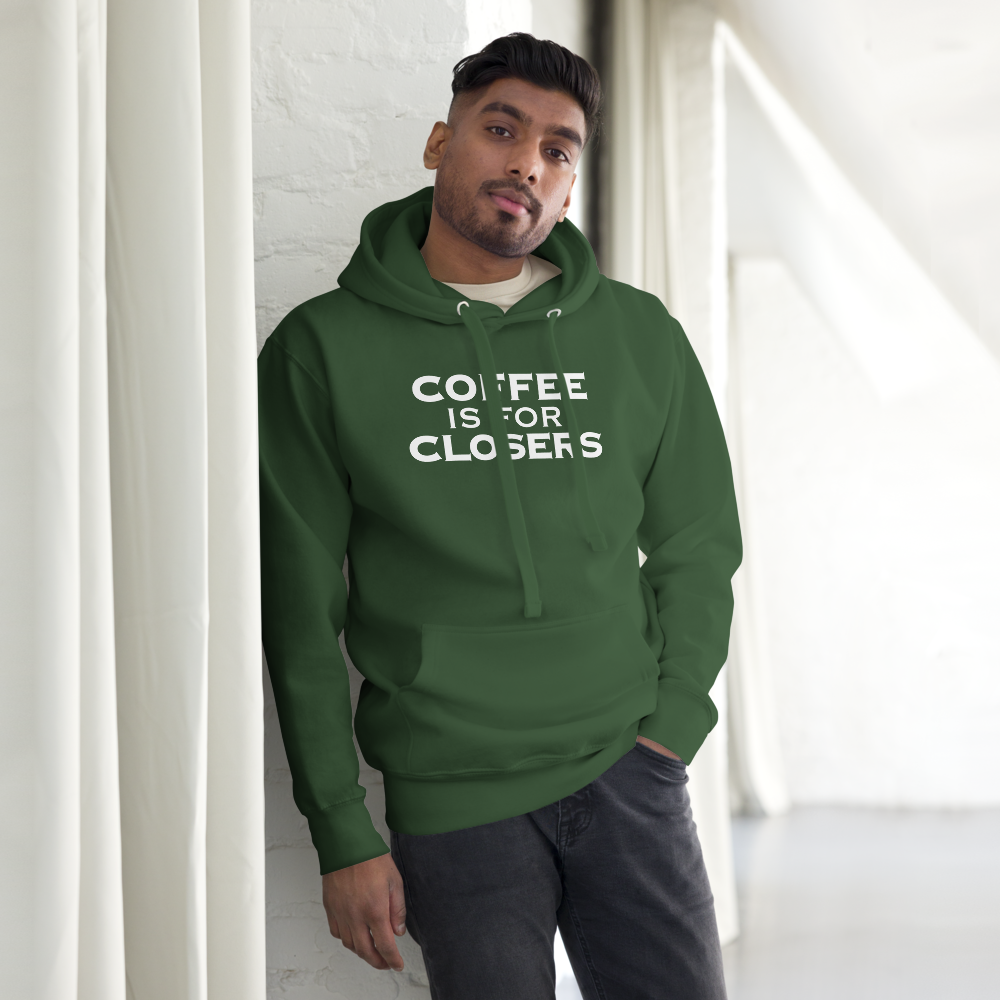 "Coffee Is For Closers" printed on a forest green unisex hoodie worn by a male