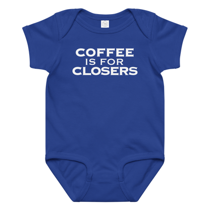 "Coffee Is For Closers" printed on a royal baby jersey bodysuit laying on a flat surface amongst other clothes
