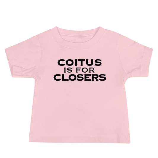 "Coitus Is For Closers" printed on a pink baby jersey short sleeve tee laying on a flat surface