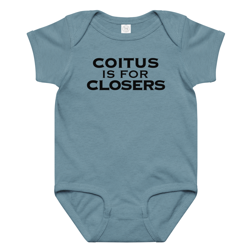 "Coitus Is For Closers" printed on a vintage indigo baby jersey bodysuit laying on a flat surface amongst other clothes