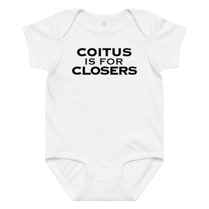 "Coitus Is For Closers" printed on a white baby jersey bodysuit laying on a flat surface amongst other clothes