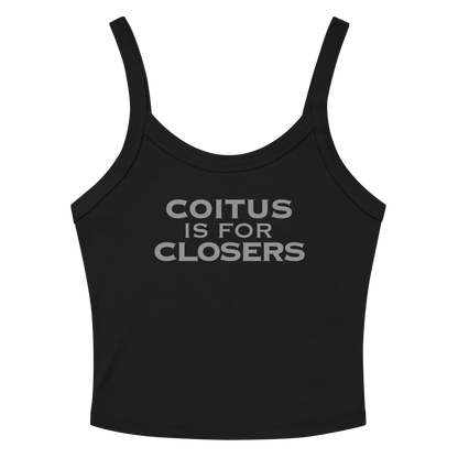 "Coitus Is For Closers" printed on a solid black blend women's micro-rib tanktop laying on a flat surface amongst sunglasses and shorts