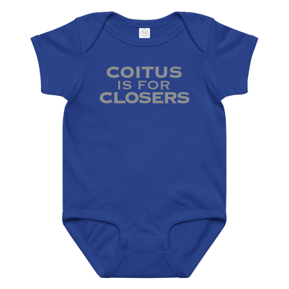 "Coitus Is For Closers" printed on a royal baby jersey bodysuit laying on a flat surface amongst other clothes