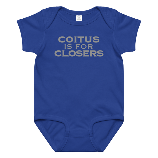 "Coitus Is For Closers" printed on a royal baby jersey bodysuit laying on a flat surface amongst other clothes