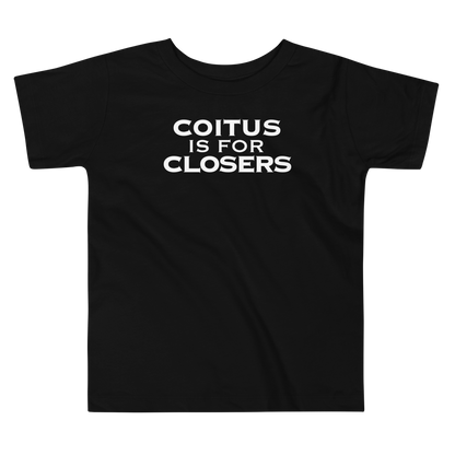 "Coitus Is For Closers" printed on a black toddler short sleeve tee laying on a flat surface