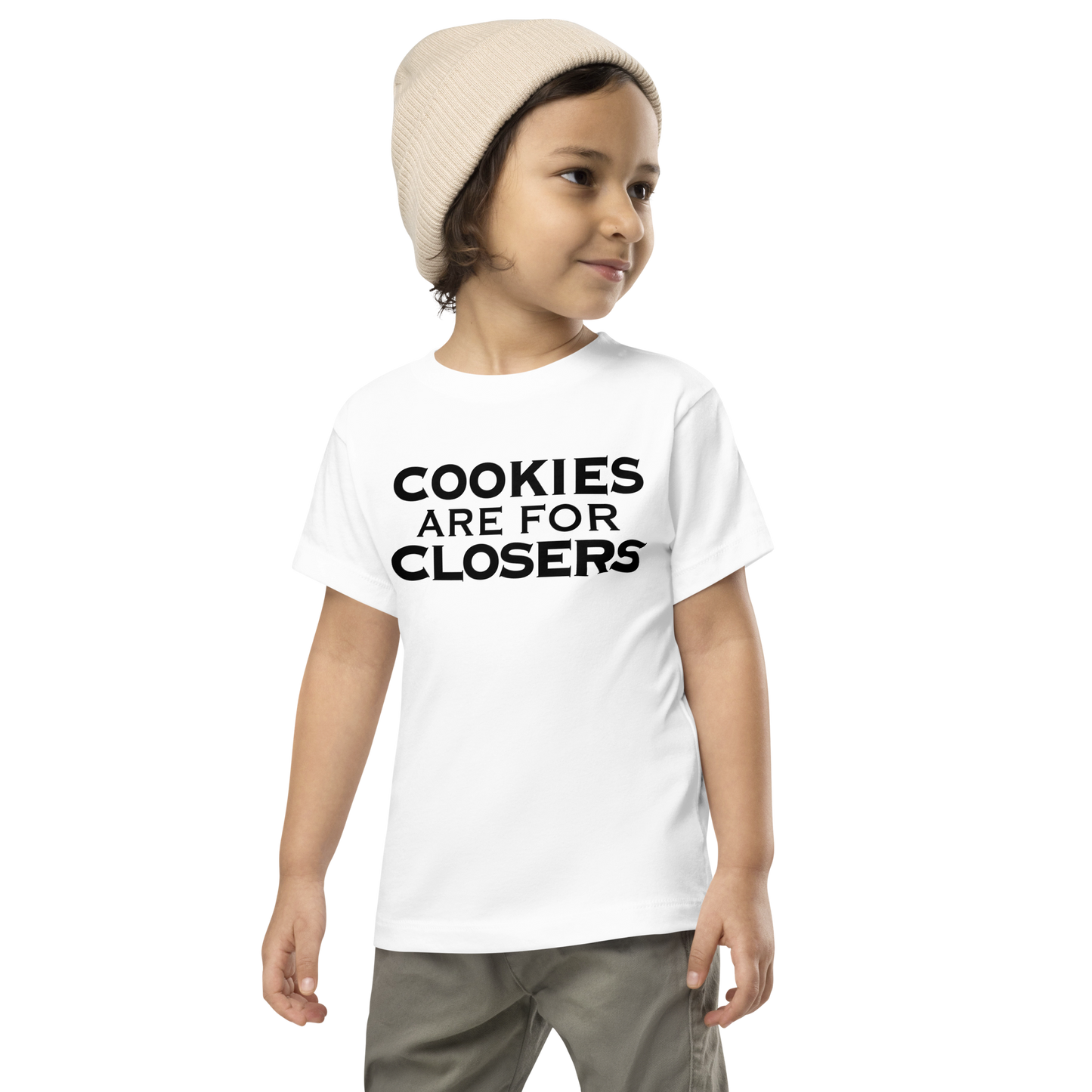 "Cookies Are For Closers" printed on a white toddler short sleeve tee worn by a male wearing a cap