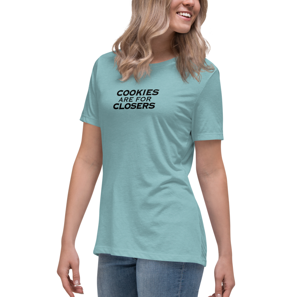 "Cookies Are For Closers" printed on a heather blue lagoon women's relaxed t-shirt worn by a female