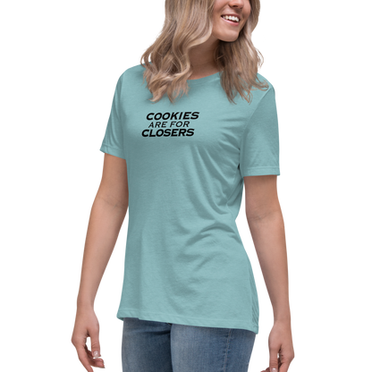"Cookies Are For Closers" printed on a heather blue lagoon women's relaxed t-shirt worn by a female