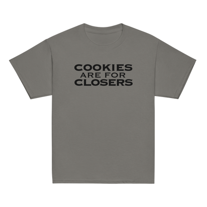 "Cookies Are For Closers" printed on a charcoal youth classic tee laying on a flat surface