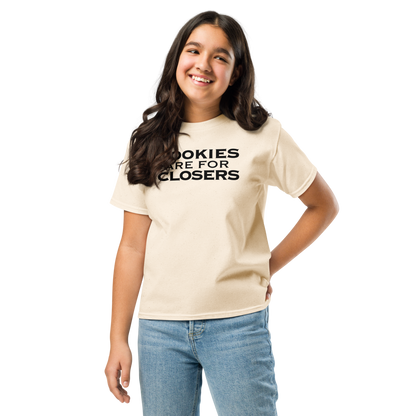 "Cookies Are For Closers" printed on a natural youth classic tee worn by a female