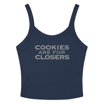 "Cookies Are For Closers" printed on a solid navy blend women's micro-rib tanktop laying on a flat surface amongst sunglasses and shorts
