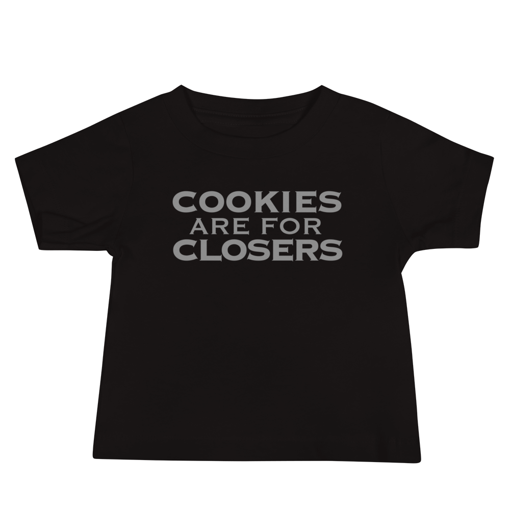 "Cookies Are For Closers" printed on a black baby jersey short sleeve tee laying on a flat surface