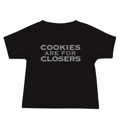 "Cookies Are For Closers" printed on a black baby jersey short sleeve tee laying on a flat surface