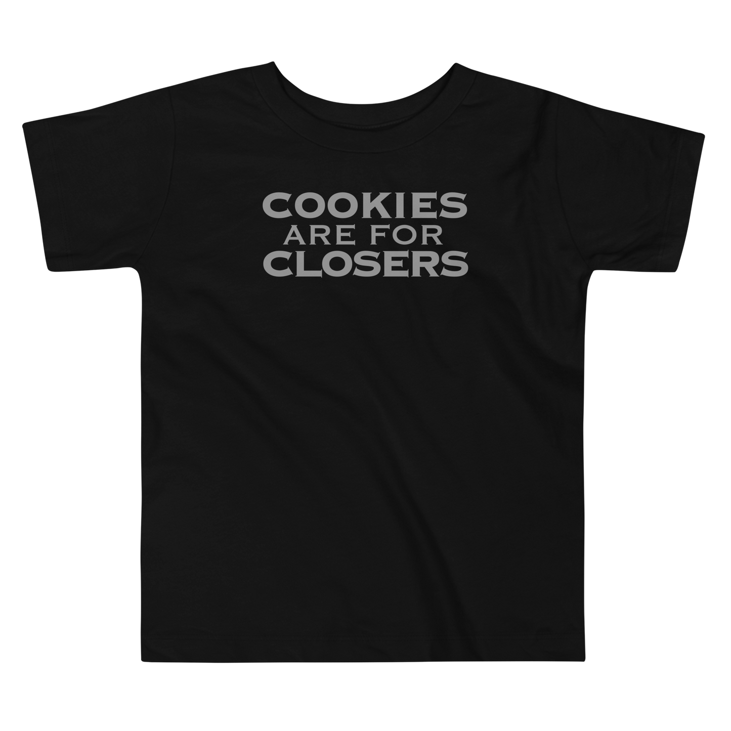 "Cookies Are For Closers" printed on a black toddler short sleeve tee laying on a flat surface
