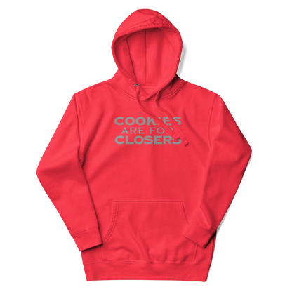"Cookies Are For Closers" printed on a team red unisex hoodie laying on a flat surface with the hood up
