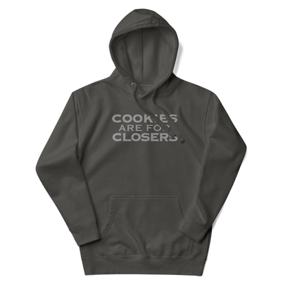 "Cookies Are For Closers" printed on a vintage black unisex hoodie laying on a flat surface with the hood up