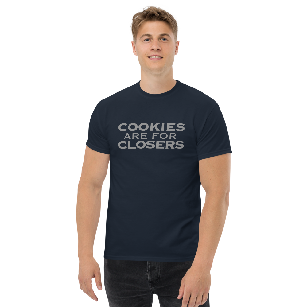 "Cookies Are For Closers" printed on a navy unisex classic tee worn by a male
