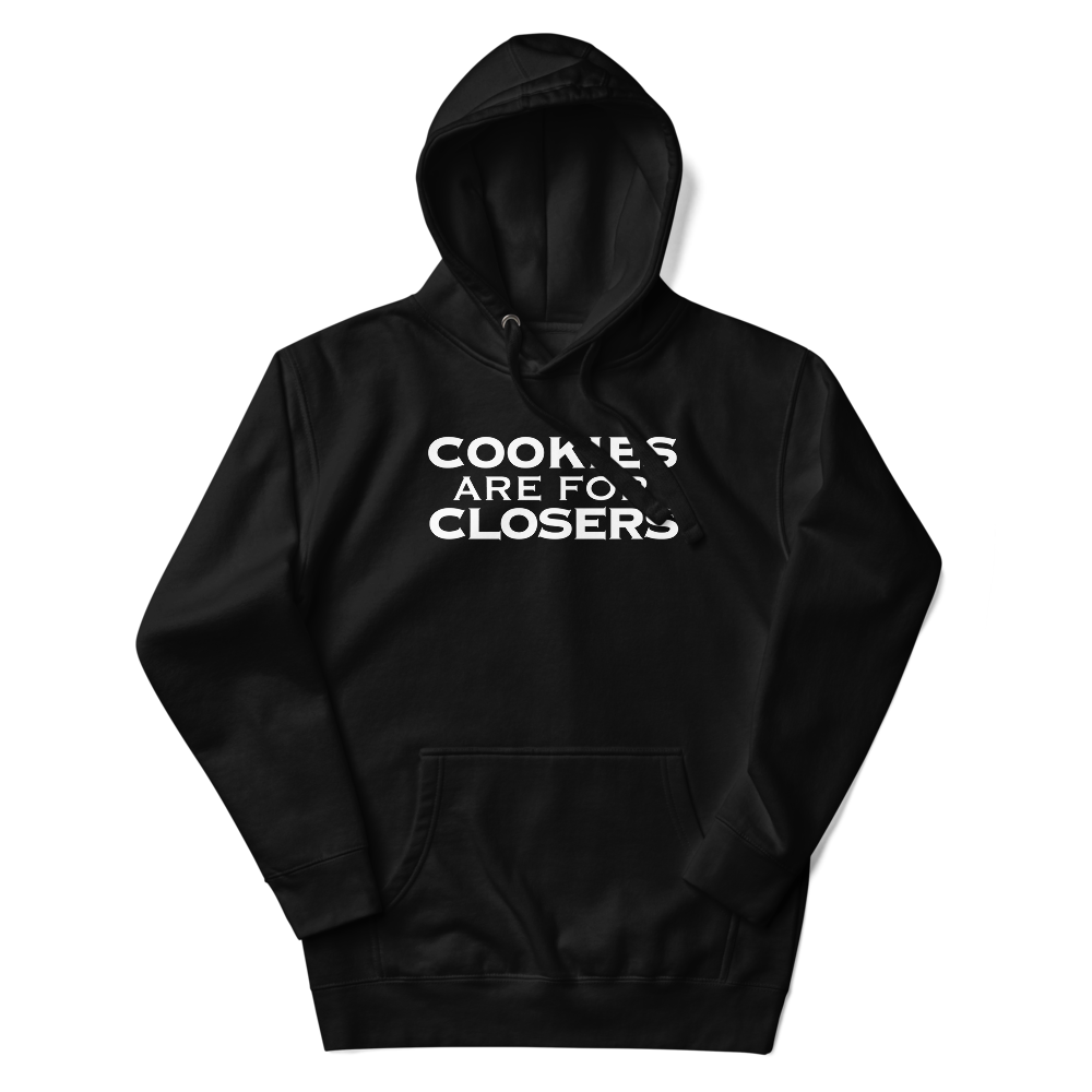 "Cookies Are For Closers" printed on a black unisex hoodie laying on a flat surface with the hood up