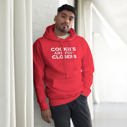 "Cookies Are For Closers" printed on a team red unisex hoodie worn by a male