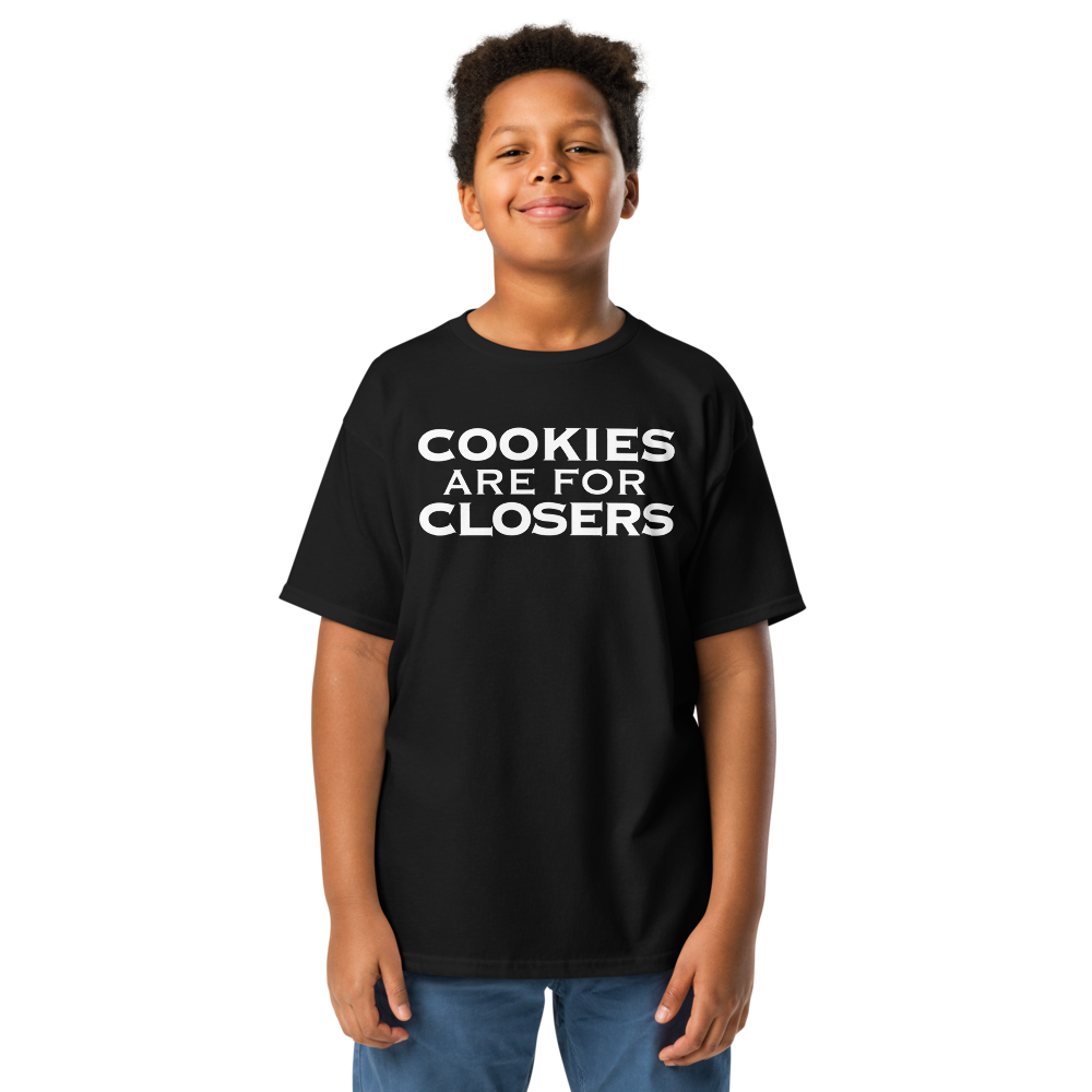 "Cookies Are For Closers" printed on a black youth classic tee worn by a male