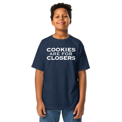 "Cookies Are For Closers" printed on a navy youth classic tee worn by a male