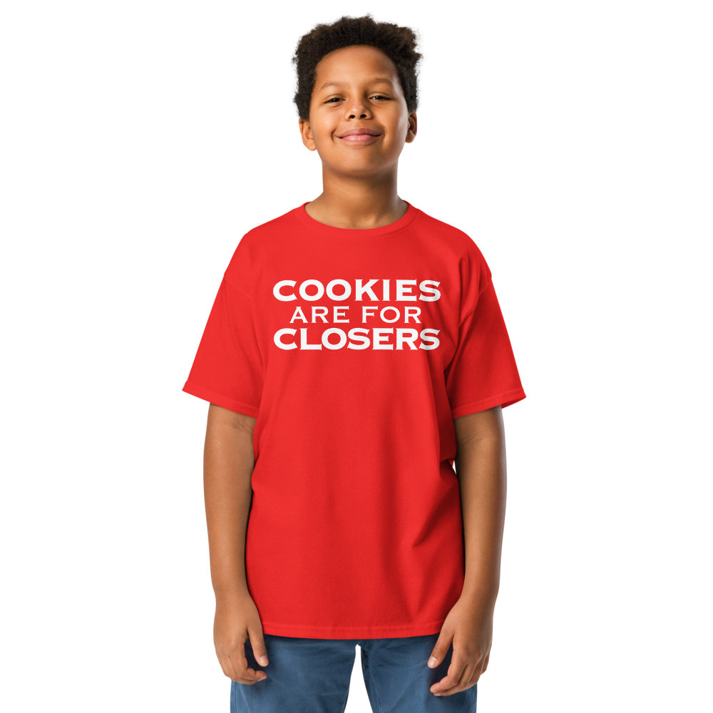 "Cookies Are For Closers" printed on a red youth classic tee worn by a male