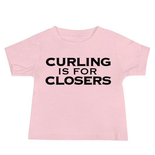 "Curling Is For Closers" printed on a pink baby jersey short sleeve tee laying on a flat surface