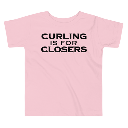 "Curling Is For Closers" printed on a pink toddler short sleeve tee laying on a flat surface