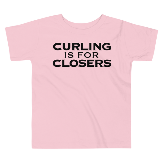 "Curling Is For Closers" printed on a pink toddler short sleeve tee laying on a flat surface