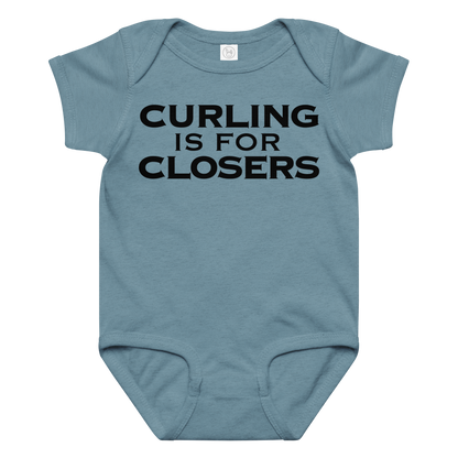 "Curling Is For Closers" printed on a vintage indigo baby jersey bodysuit laying on a flat surface amongst other clothes