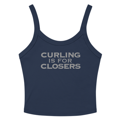"Curling Is For Closers" printed on a solid navy blend women's micro-rib tanktop laying on a flat surface amongst sunglasses and shorts