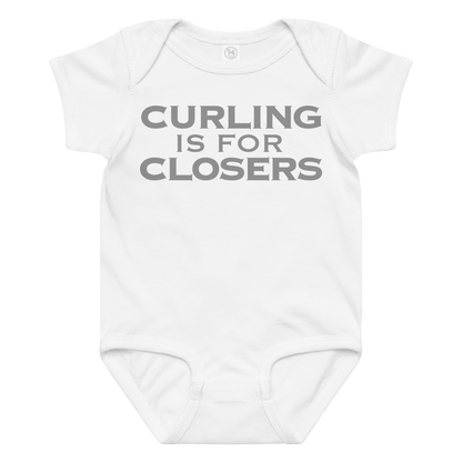"Curling Is For Closers" printed on a white baby jersey bodysuit laying on a flat surface amongst other clothes